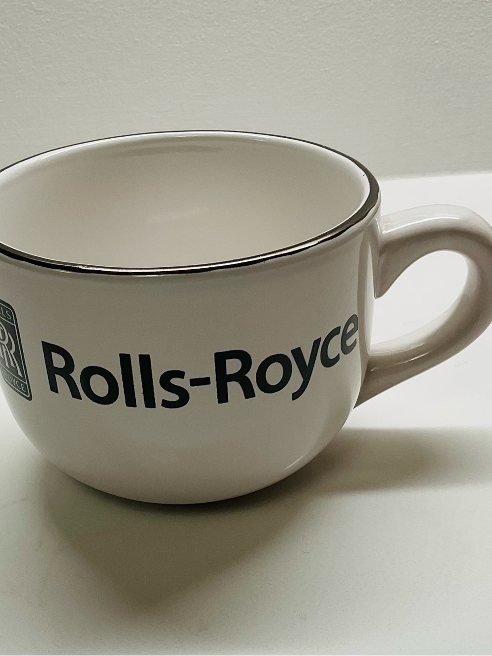 Rolls Royce Logo Coffee Mug. White China with Black Print and Silver Rim.